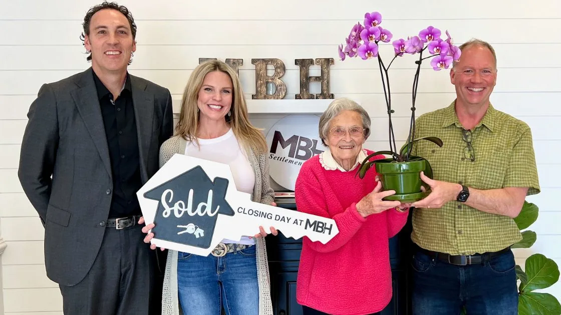 The Bill Denny Real Estate Group celebrating a home closing with a client at MBH Settlement Group