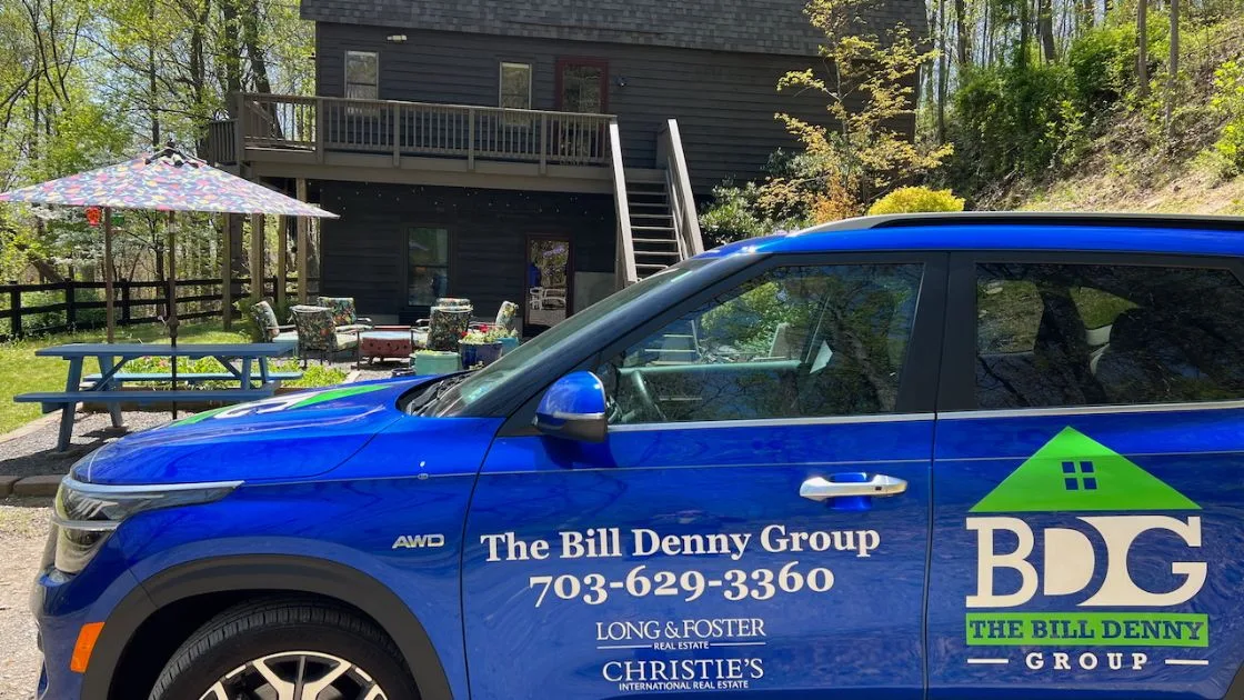 A Bill Denny Real Estate Group vehicle parked outside a home in the Gainesville, VA area