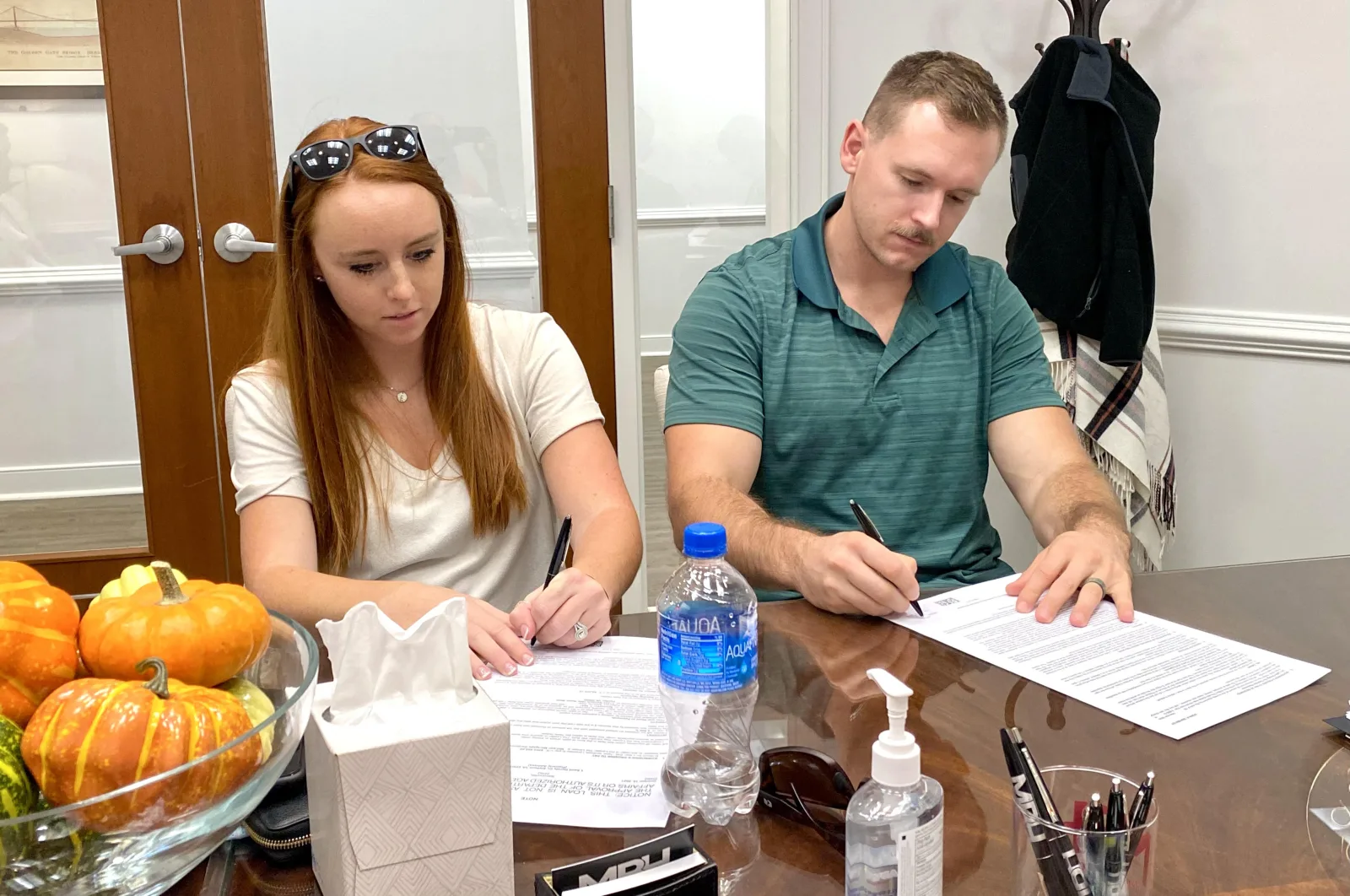 Bill Denny Group clients signing real estate transaction paperwork